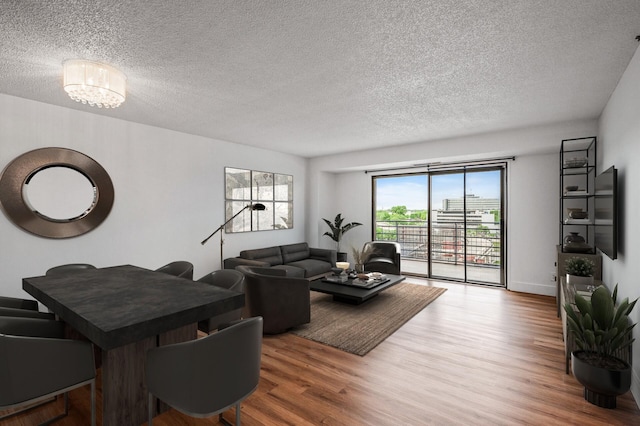 26 10th St W Unit 1108, Saint Paul, MN 55102 - living area with a textured ceiling, wood finished floors, and a chandelier