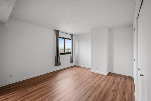 26 10th St W Unit 1108, Saint Paul, MN 55102 - unfurnished room featuring a textured ceiling, wood finished floors, and baseboards