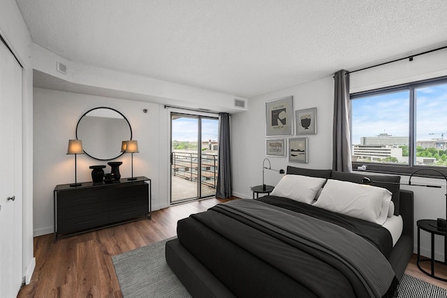 26 10th St W Unit 1108, Saint Paul, MN 55102 - bedroom with access to outside, a textured ceiling, wood finished floors, and baseboards