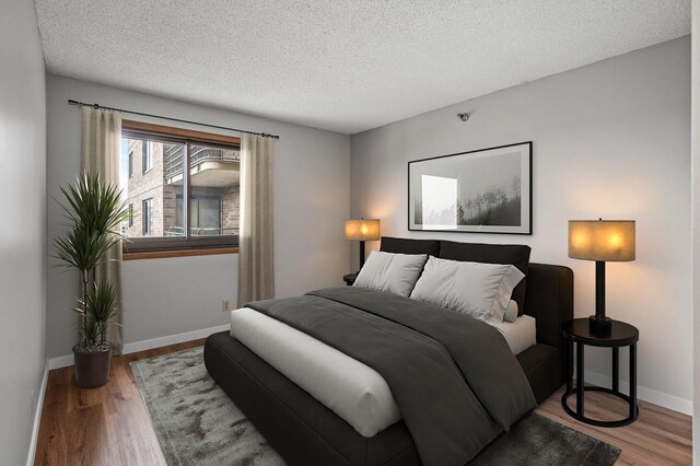26 10th St W Unit 1108, Saint Paul, MN 55102 - bedroom with a textured ceiling, wood finished floors, and baseboards