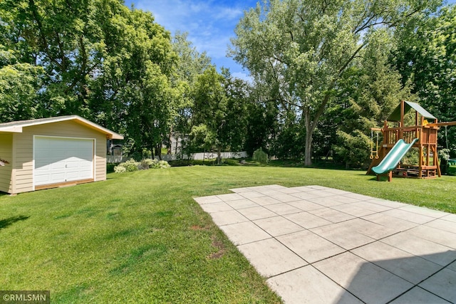 2119 13th Ave E, North Saint Paul, MN 55109 - view of green lawn featuring a playground, a detached garage, view of wooded area, and an outdoor structure