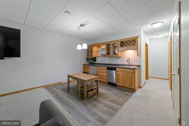 2119 13th Ave E, North Saint Paul, MN 55109 - kitchen with stainless steel appliances, dark countertops, brown cabinetry, glass insert cabinets, and light carpet