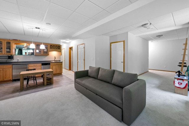 2119 13th Ave E, North Saint Paul, MN 55109 - living area with light carpet, a paneled ceiling, and bar with sink