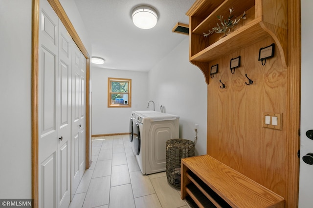 2119 13th Ave E, North Saint Paul, MN 55109 - washroom with light tile patterned floors and washer and clothes dryer