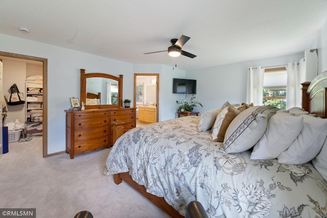 2119 13th Ave E, North Saint Paul, MN 55109 - bedroom featuring light carpet, a spacious closet, and a ceiling fan