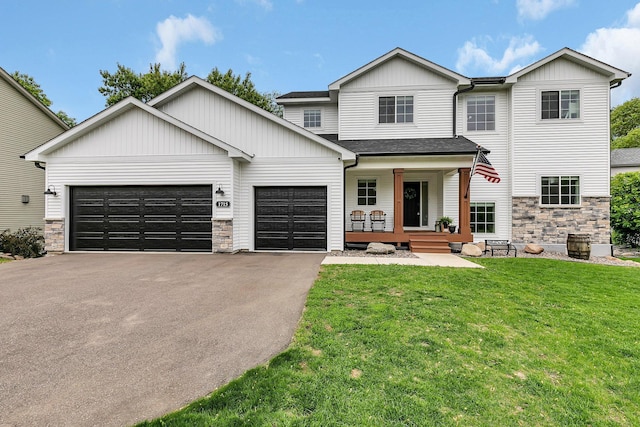 1715 Par Ln, Buffalo, MN 55313 - view of front of property with a porch, stone siding, asphalt driveway, a garage, and a front lawn