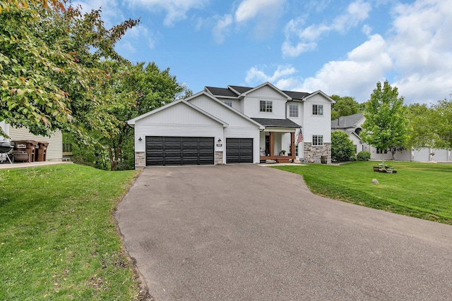 1715 Par Ln, Buffalo, MN 55313 - view of front of house featuring stone siding, asphalt driveway, an attached garage, a front yard, and board and batten siding