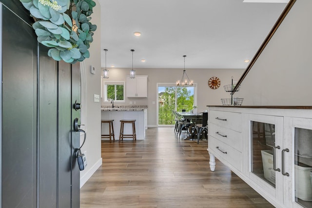 1715 Par Ln, Buffalo, MN 55313 - entrance foyer featuring wood finished floors, recessed lighting, a chandelier, and baseboards