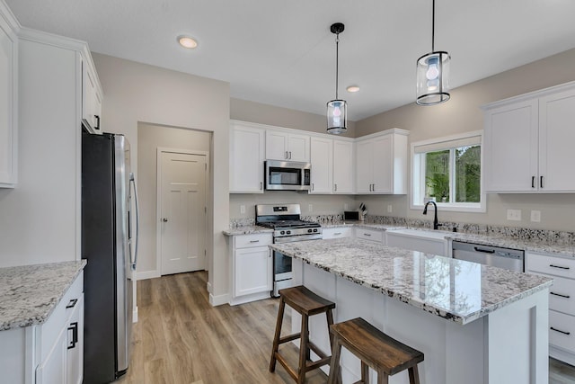 1715 Par Ln, Buffalo, MN 55313 - kitchen with stainless steel appliances, light wood finished floors, white cabinetry, and recessed lighting