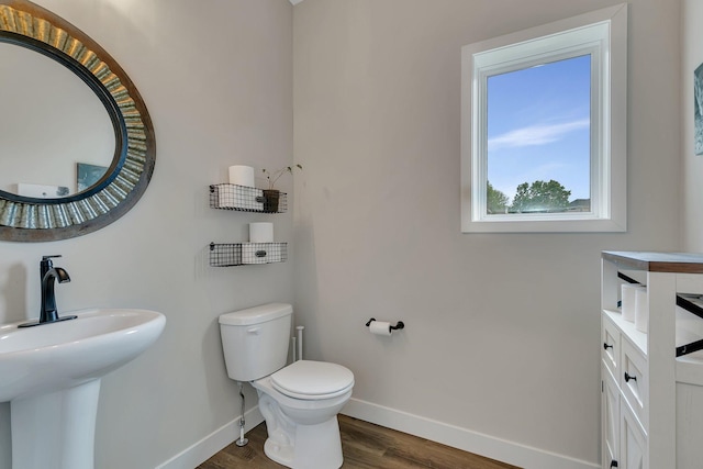 1715 Par Ln, Buffalo, MN 55313 - half bath featuring baseboards, wood finished floors, toilet, and a sink
