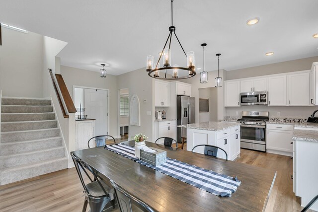 1715 Par Ln, Buffalo, MN 55313 - dining space with light wood-style flooring, stairway, a chandelier, and recessed lighting