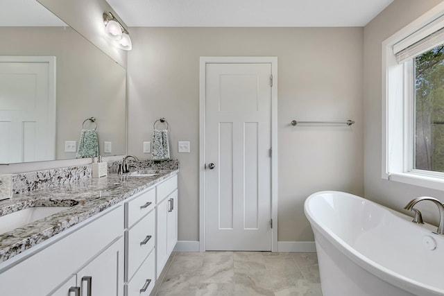 1715 Par Ln, Buffalo, MN 55313 - bathroom featuring baseboards, a soaking tub, double vanity, and marble look tiles