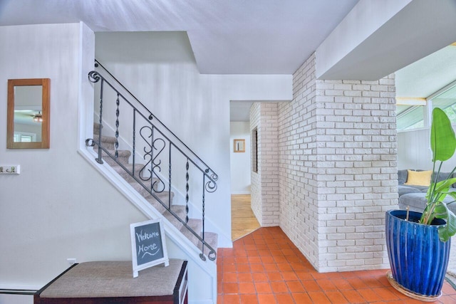 417 Main St S, Aurora, MN 55705 - stairway featuring tile patterned floors and brick wall