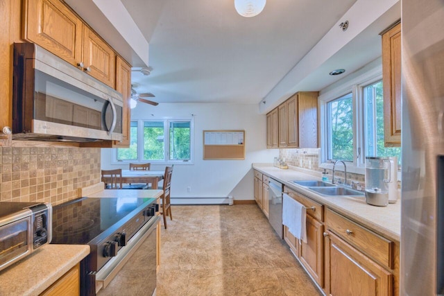 417 Main St S, Aurora, MN 55705 - kitchen featuring stainless steel appliances, a baseboard radiator, ceiling fan, tasteful backsplash, and light countertops