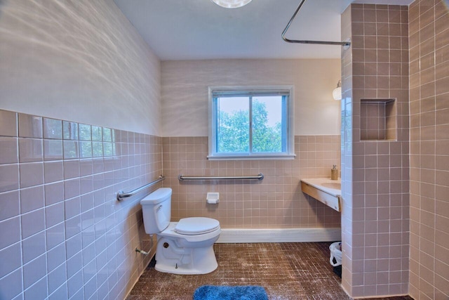 417 Main St S, Aurora, MN 55705 - full bathroom with tile walls, plenty of natural light, a tile shower, tile patterned flooring, and a wainscoted wall