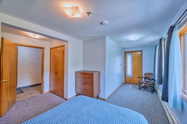 417 Main St S, Aurora, MN 55705 - carpeted bedroom with baseboards and a baseboard radiator