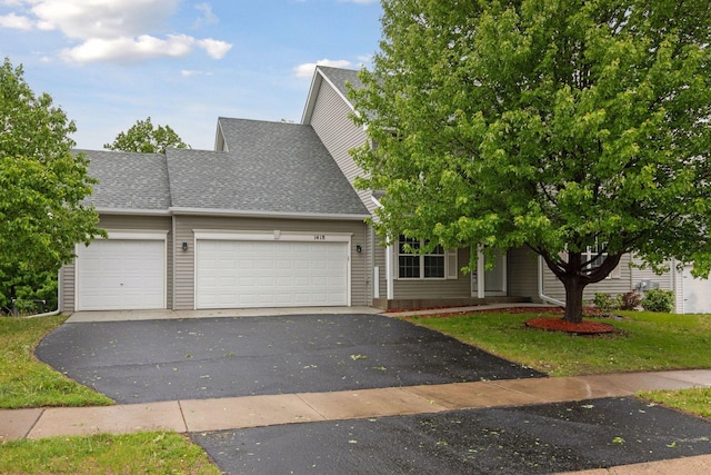 1418 Bluff St, Dundas, MN 55019 - view of front of property with an attached garage, driveway, a shingled roof, and a front yard