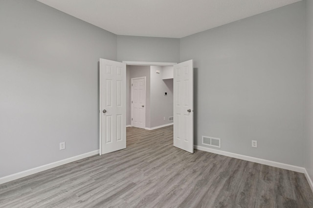 1418 Bluff St, Dundas, MN 55019 - unfurnished room featuring wood finished floors and baseboards