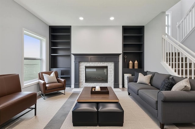 1418 Bluff St, Dundas, MN 55019 - living room featuring built in shelves, a fireplace, stairs, and recessed lighting