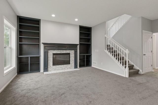 1418 Bluff St, Dundas, MN 55019 - unfurnished living room with built in features, plenty of natural light, stairway, carpet flooring, and recessed lighting