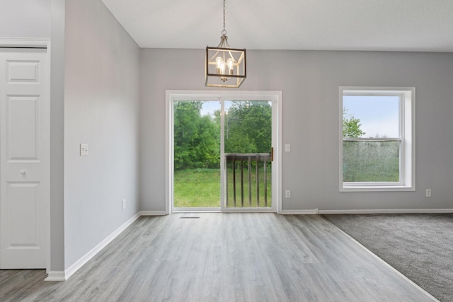 1418 Bluff St, Dundas, MN 55019 - unfurnished dining area with a chandelier and wood finished floors
