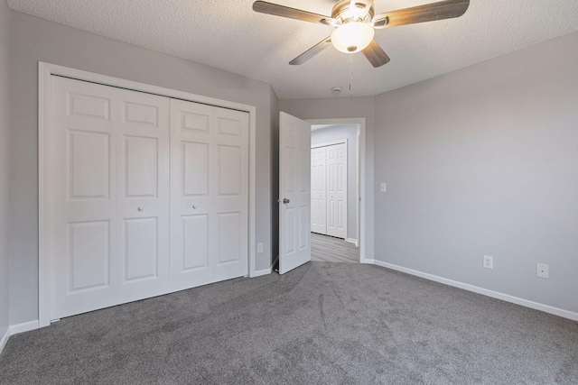 1418 Bluff St, Dundas, MN 55019 - unfurnished bedroom featuring dark colored carpet, a closet, a textured ceiling, and ceiling fan