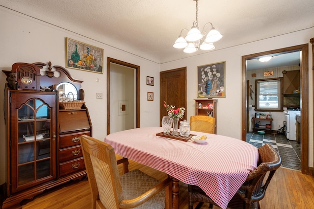 241 Queen Ave S, Minneapolis, MN 55405 - dining space featuring a chandelier and wood finished floors