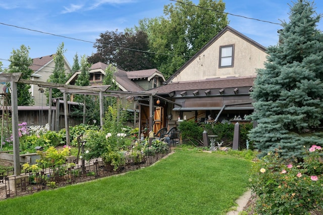 241 Queen Ave S, Minneapolis, MN 55405 - rear view of property featuring stucco siding, a vegetable garden, and a shingled roof