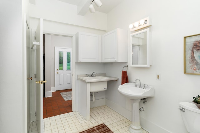 1101 Skyline Pkwy, Duluth, MN 55805 - bathroom with tile patterned floors, toilet, and baseboards