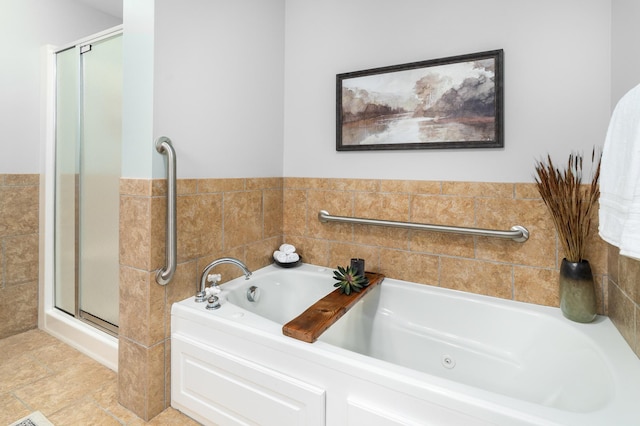 1101 Skyline Pkwy, Duluth, MN 55805 - bathroom with a stall shower, a garden tub, and tile walls