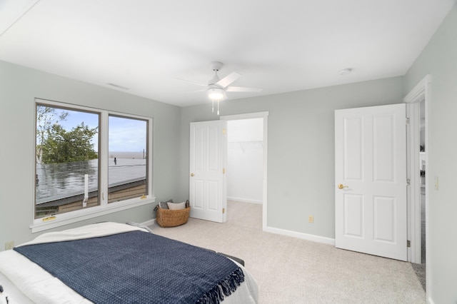 1101 Skyline Pkwy, Duluth, MN 55805 - carpeted bedroom with baseboards, a ceiling fan, and a walk in closet