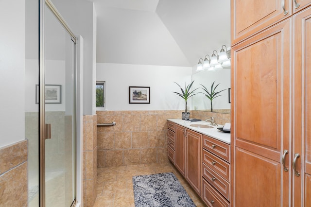 1101 Skyline Pkwy, Duluth, MN 55805 - bathroom with lofted ceiling, vanity, a stall shower, tile walls, and tile patterned floors