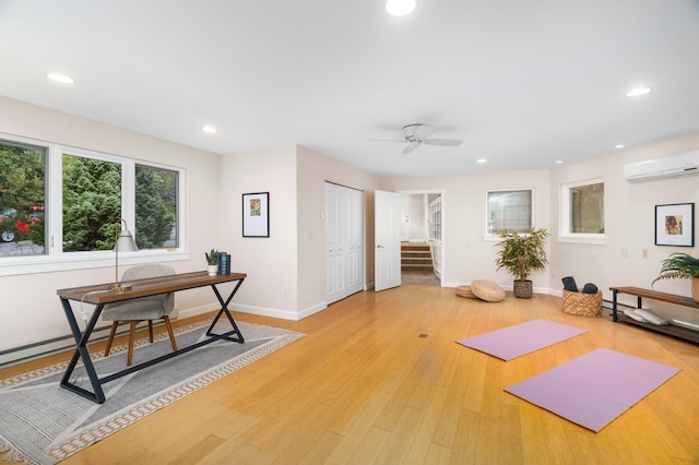 1101 Skyline Pkwy, Duluth, MN 55805 - workout room with a wall unit AC, baseboards, recessed lighting, a ceiling fan, and light wood-style floors