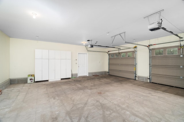 1101 Skyline Pkwy, Duluth, MN 55805 - garage featuring a garage door opener and baseboards