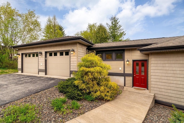 1101 Skyline Pkwy, Duluth, MN 55805 - view of front of home with driveway, a garage, and a shingled roof