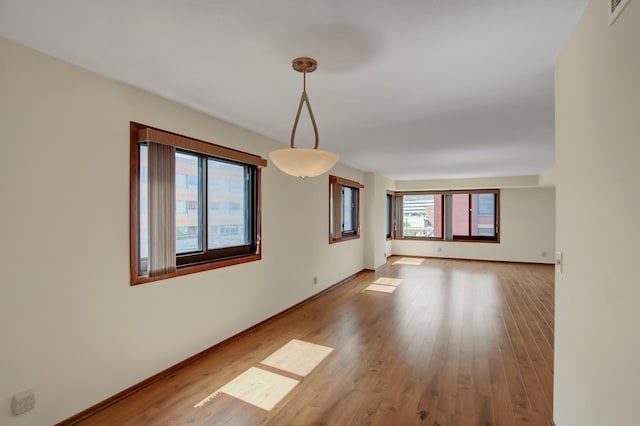 26 10th St W Unit 502, Saint Paul, MN 55102 - spare room featuring wood finished floors and baseboards