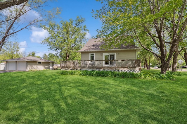 381 Ormsbee St, Big Lake, MN 55309 - view of green lawn featuring a deck, an outdoor structure, and a garage