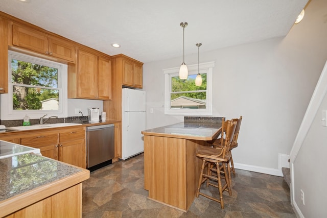 381 Ormsbee St, Big Lake, MN 55309 - kitchen featuring stainless steel dishwasher, freestanding refrigerator, stone finish floors, healthy amount of natural light, and recessed lighting