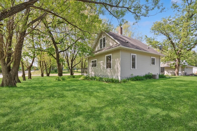 381 Ormsbee St, Big Lake, MN 55309 - view of side of property with a chimney, a yard, and a shingled roof