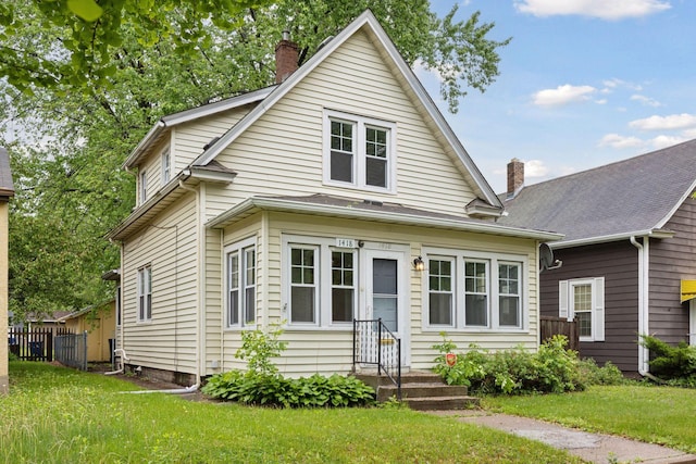 1418 Payne Ave, Saint Paul, MN 55130 - view of front of property featuring a chimney and a front yard