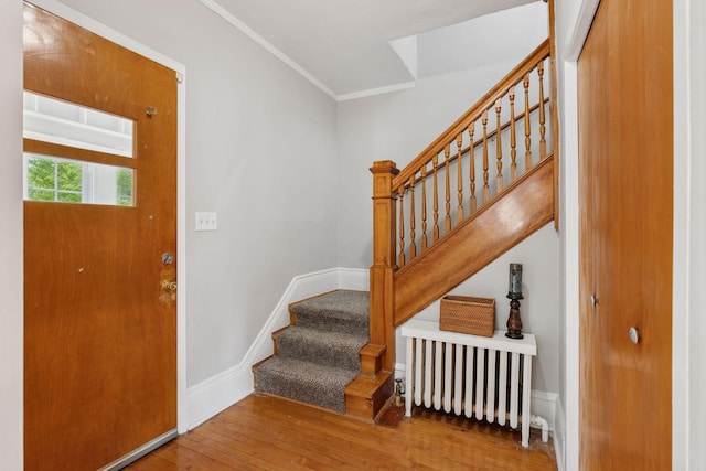 1418 Payne Ave, Saint Paul, MN 55130 - entryway featuring stairs, hardwood / wood-style flooring, crown molding, and radiator heating unit