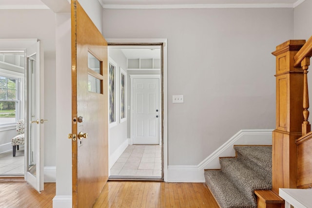 1418 Payne Ave, Saint Paul, MN 55130 - entryway featuring light wood-type flooring, stairs, and crown molding