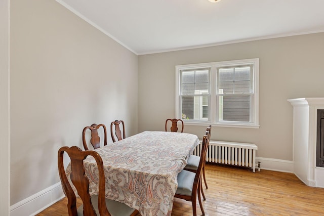 1418 Payne Ave, Saint Paul, MN 55130 - dining room with radiator, crown molding, and light wood-type flooring