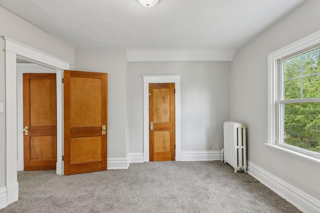 1418 Payne Ave, Saint Paul, MN 55130 - unfurnished bedroom with radiator heating unit, carpet floors, and multiple windows