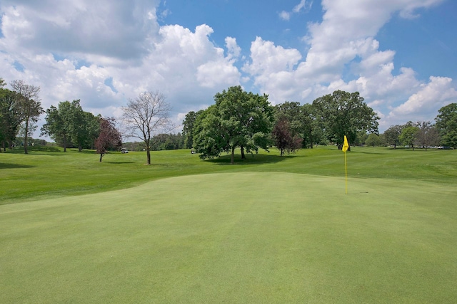 1418 Payne Ave, Saint Paul, MN 55130 - view of property's community featuring golf course view, a lawn, an area to practice putting, and view of wooded area