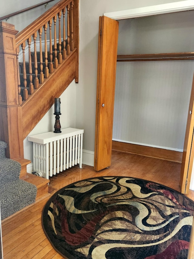1418 Payne Ave, Saint Paul, MN 55130 - staircase featuring wood-type flooring and radiator heating unit