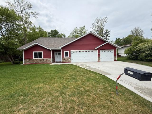 6207 Lagoon Dr NE, Bemidji, MN 56601 - ranch-style house featuring driveway, stone siding, a garage, and a front yard