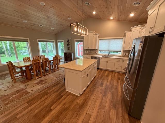 6207 Lagoon Dr NE, Bemidji, MN 56601 - kitchen featuring appliances with stainless steel finishes, lofted ceiling, wooden ceiling, light countertops, and white cabinets