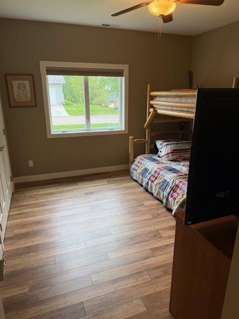6207 Lagoon Dr NE, Bemidji, MN 56601 - bedroom with light wood-type flooring, baseboards, and a ceiling fan