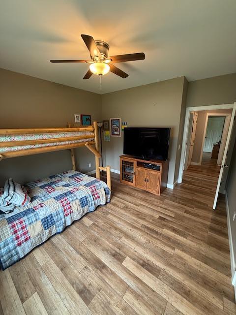 6207 Lagoon Dr NE, Bemidji, MN 56601 - bedroom with wood finished floors, baseboards, and a ceiling fan